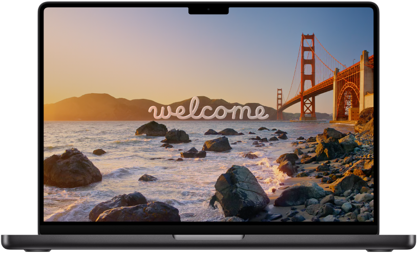 An open MacBook Pro with “Welcome” on the screen.