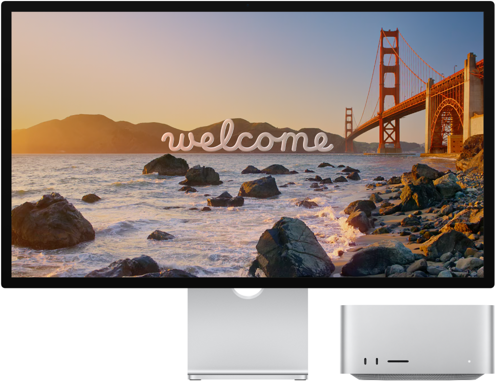 Экранында «Welcome» сөзі бар қатар тұрған Studio Display және Mac Studio.