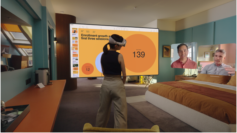 A person wearing Apple&nbsp;Vision&nbsp;Pro and having a FaceTime call. The tiles for others on the call are visible next to a shared screen.