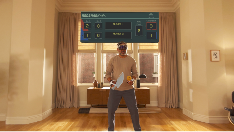 A person playing a game in Apple Arcade on Apple&nbsp;Vision&nbsp;Pro, using a connected controller.