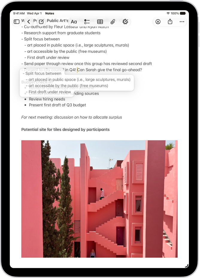 A document is open in the Notes app. Selected text is lifted within the document to be moved to a new location.