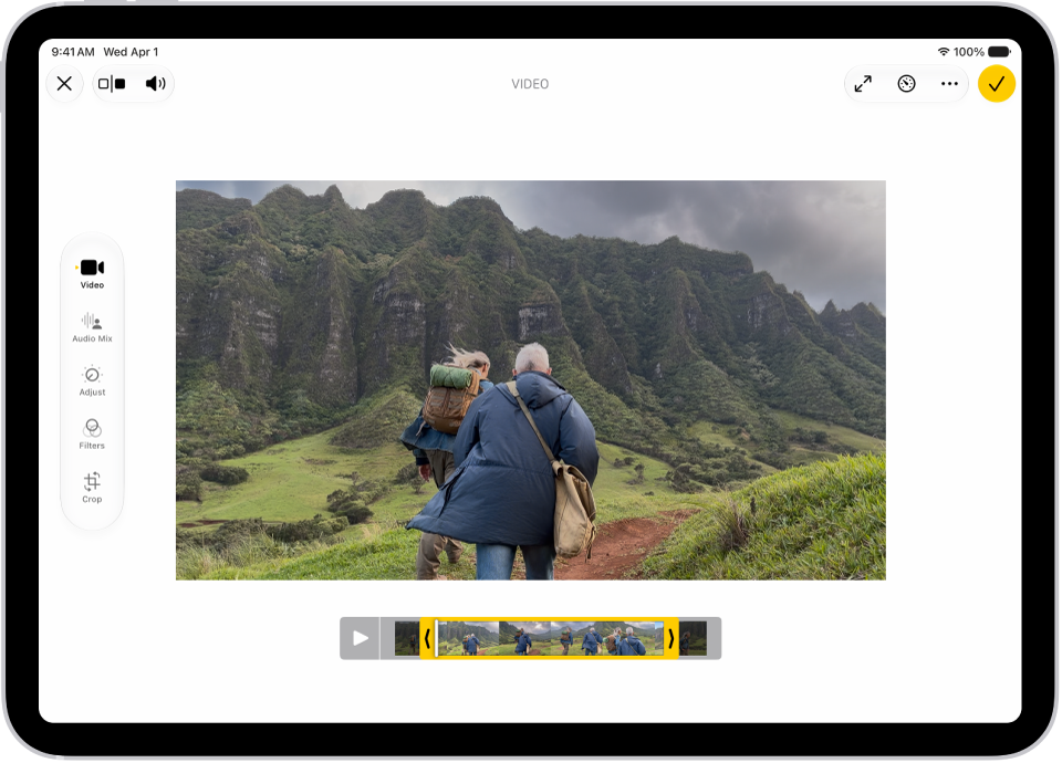 The Edit screen in the Photos app with a video playing in the center. The video’s frame viewer is across the bottom of the video and a yellow outline is around the selected frames to include in the trimmed video. On the left side of the screen are the Video, Adjust, Filters, and Crop buttons; the Video button is selected.