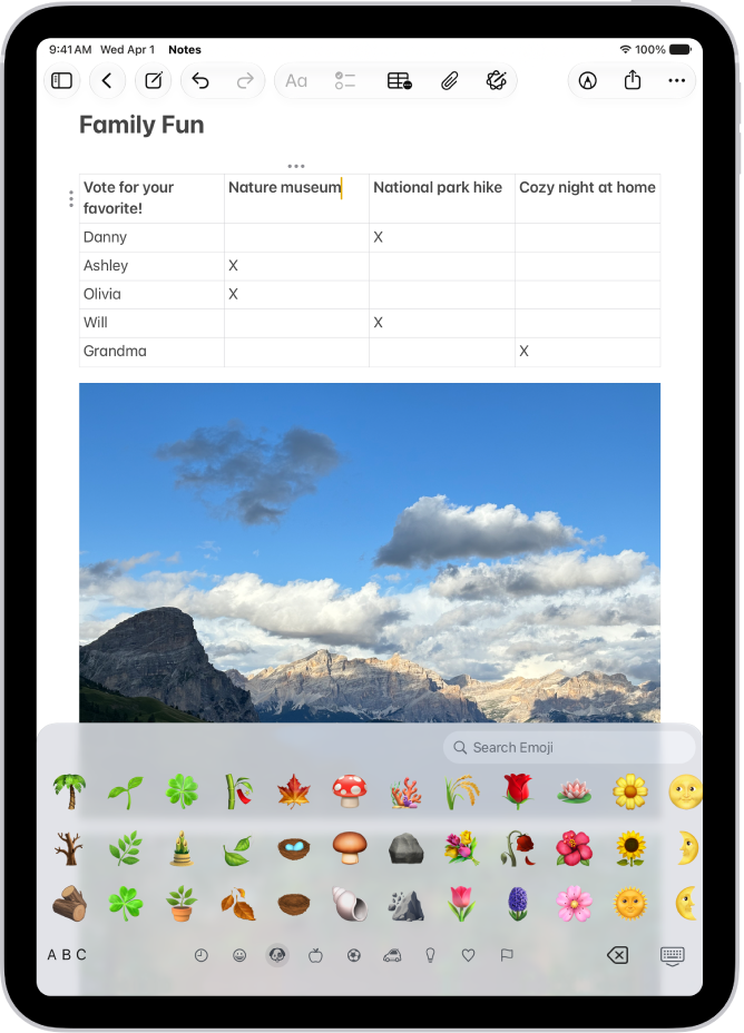 A note is open in the Notes app in the top of the screen, and the emoji keyboard is open in the bottom of the screen.
