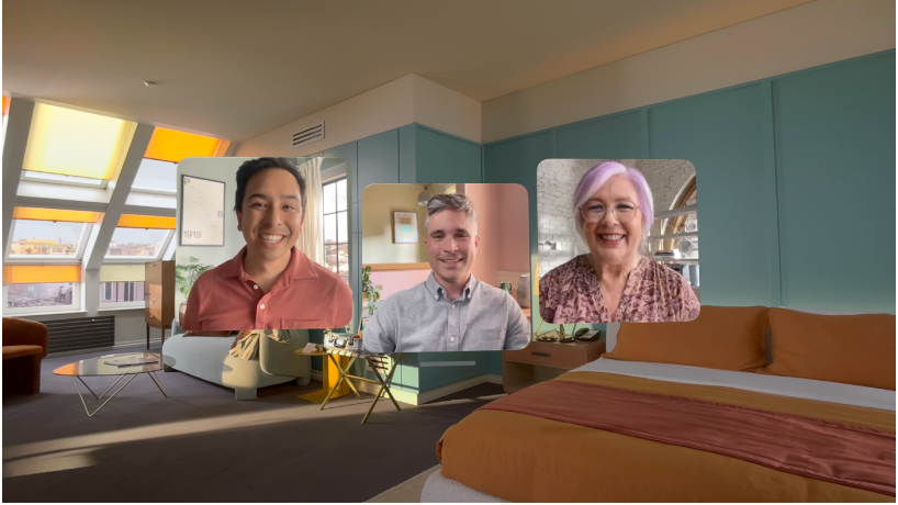 A FaceTime call on Apple&nbsp;Vision&nbsp;Pro, showing three tiles from other participants overlaying the user’s room.
