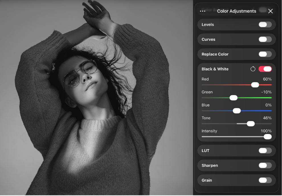 A monochrome-converted image of a person in the canvas, with the Color Adjustments pane beside it showing the Black & White controls.