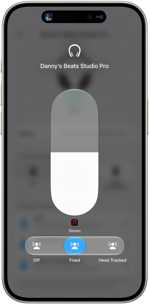 The volume screen in Control Centre showing the volume level for Studio Pro headphones. Below the volume indicator, the Spatial Audio options are shown. The options are Off, Fixed and Head Tracked.