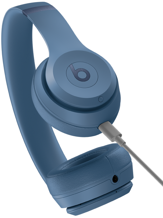 USB-C cable connected to the charging port on the Beats Solo&nbsp;4 right earcup (below the system button).