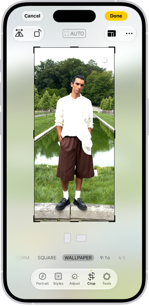 The Edit screen with a photo in the center. At the bottom of the screen, from left to right, are the Portrait, Adjust, Filters, Crop, and Clean Up buttons. The Crop button is selected and there is a slider to adjust the geometry enhancements.