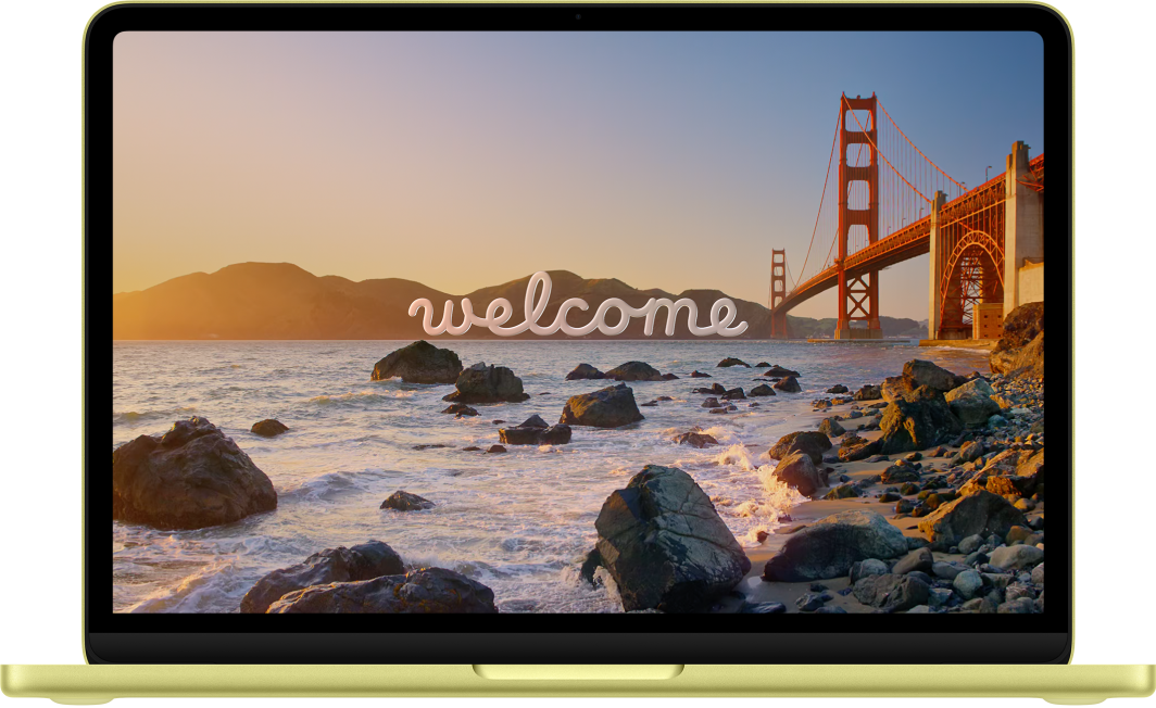 A MacBook Neo with the lid open. The display shows the word “Welcome.”