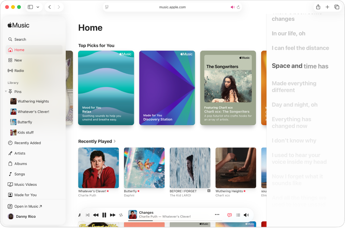 A song is playing in Apple Music. Lyrics appear on the right, in time with the music.