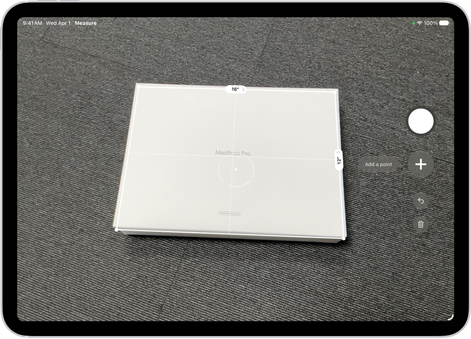 A screen showing the measurement of the dimensions of a box in the Measure app. The area of the box is calculated from the measurements of the dimensions.