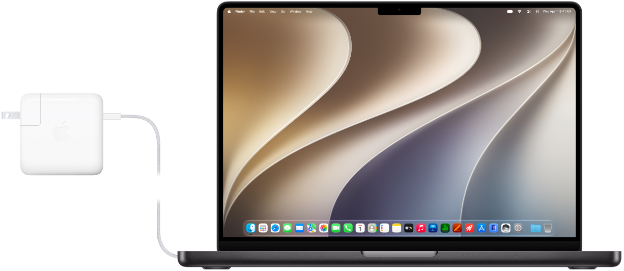A MacBook Pro with the power adapter attached.