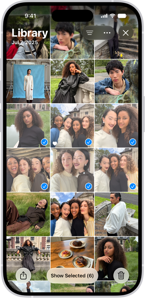 El iPhone muestra una cuadrícula de fotos que ocupa toda la pantalla, y algunas de las fotos están seleccionadas. En la parte inferior de la pantalla se encuentran los botones Compartir y Eliminar.