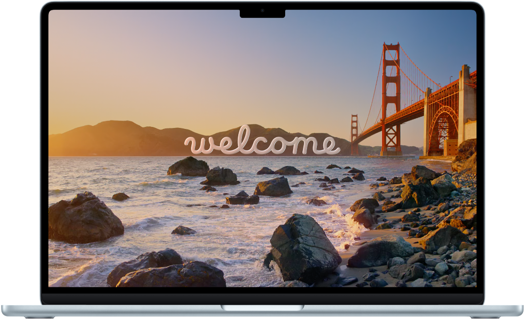 A MacBook Air with the lid open. The display shows the word “Welcome.”