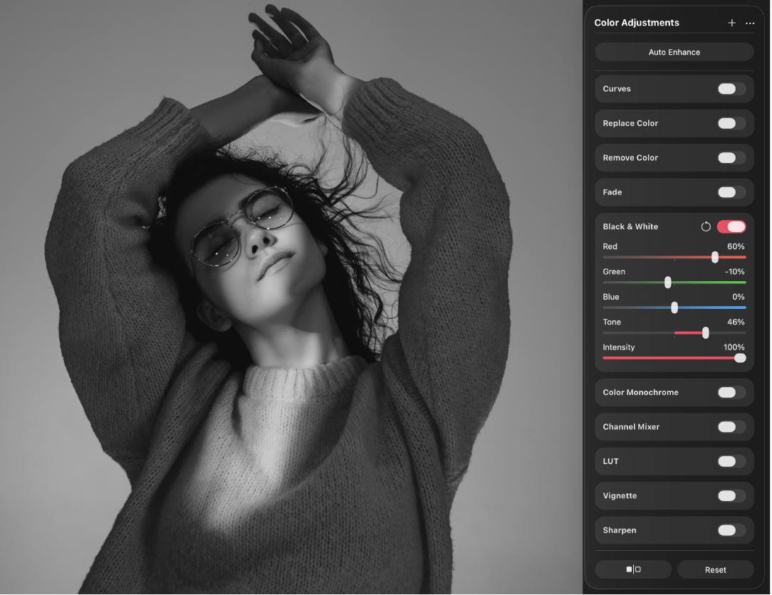 A monochrome-converted image of a person in the canvas, with the Color Adjustments pane beside it showing the Black & White controls.