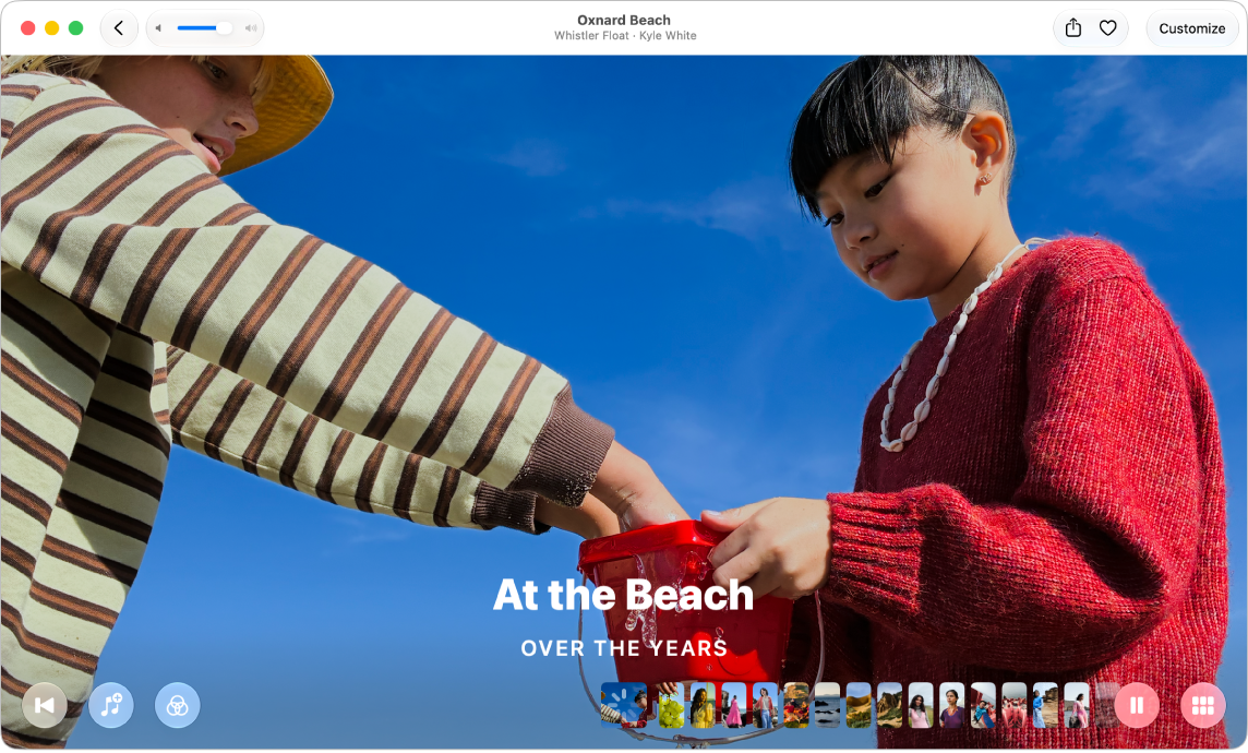 The Photos window showing a memory ready to play. A Rewind button, a Music button, a Filters button, a filmstrip with thumbnails of photos in the memory, a Play button, and a Grid View button appear at the bottom.