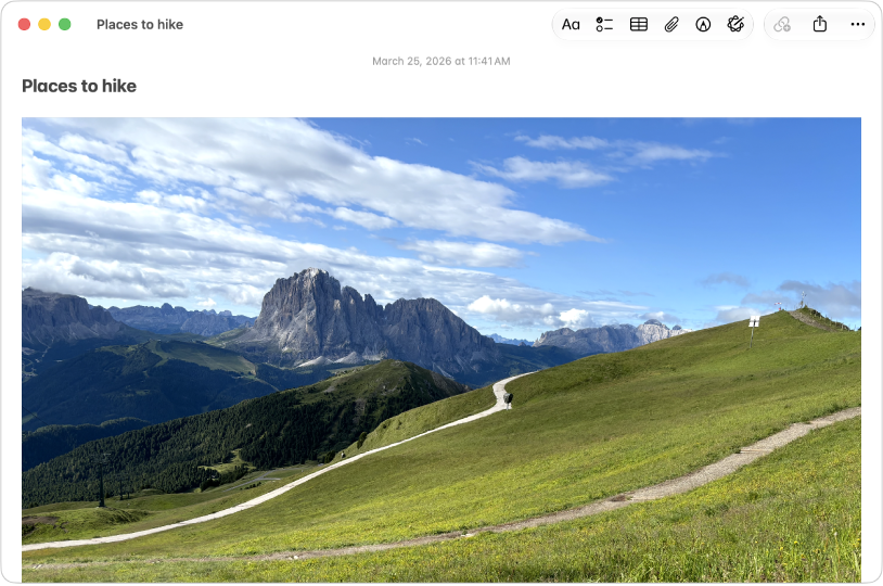 A Notes app window on Mac showing a note that includes a large photo of a hill and mountains.