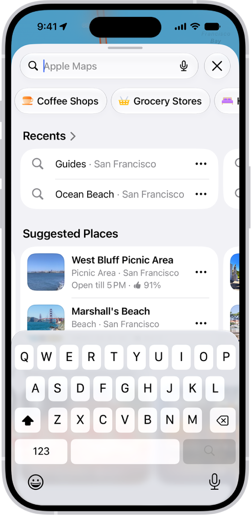 “地图” App 显示搜索栏、附近服务的类型以及城市指南。屏幕底部是 iPhone 屏幕键盘。